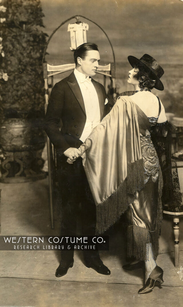 Edmund Lowe dances with woman in shawl